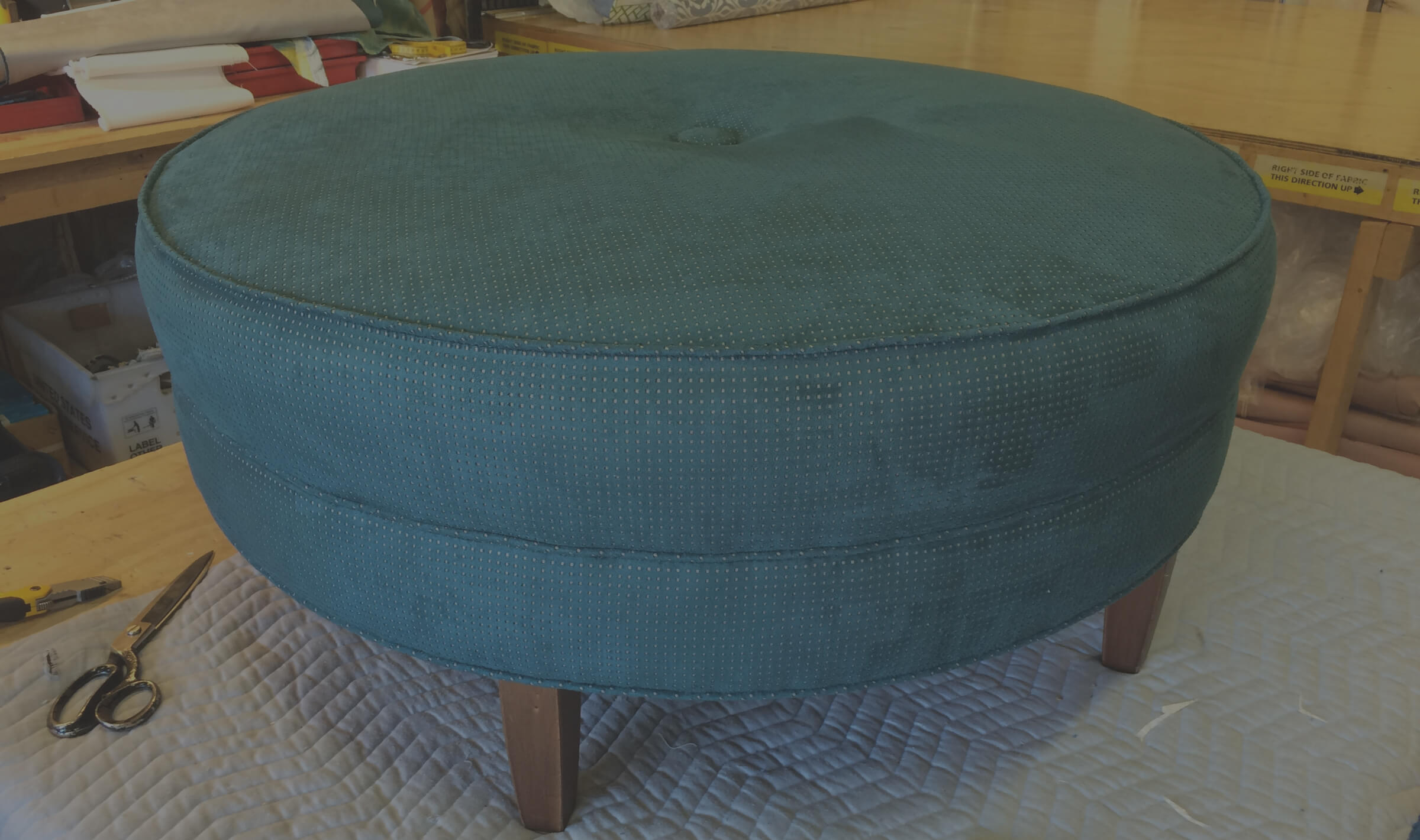 Turquoise ottoman with small spots