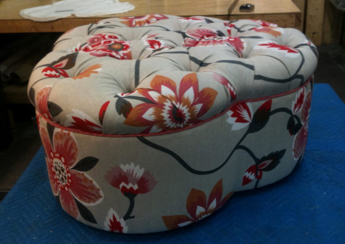 Gray ottoman with red floral designs