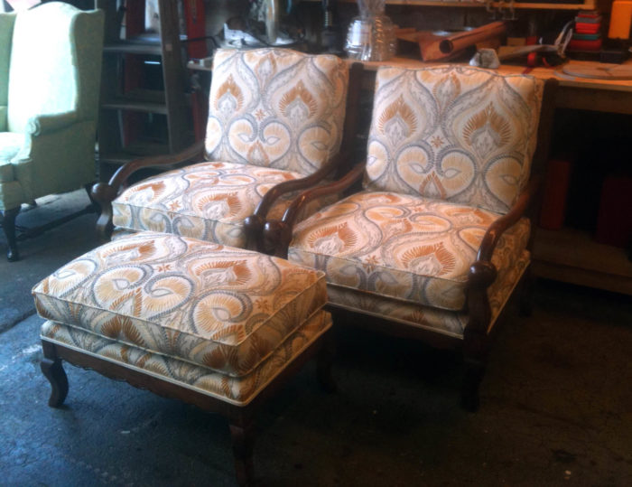 Newly reupholstered bergere chairs and a matching ottoman