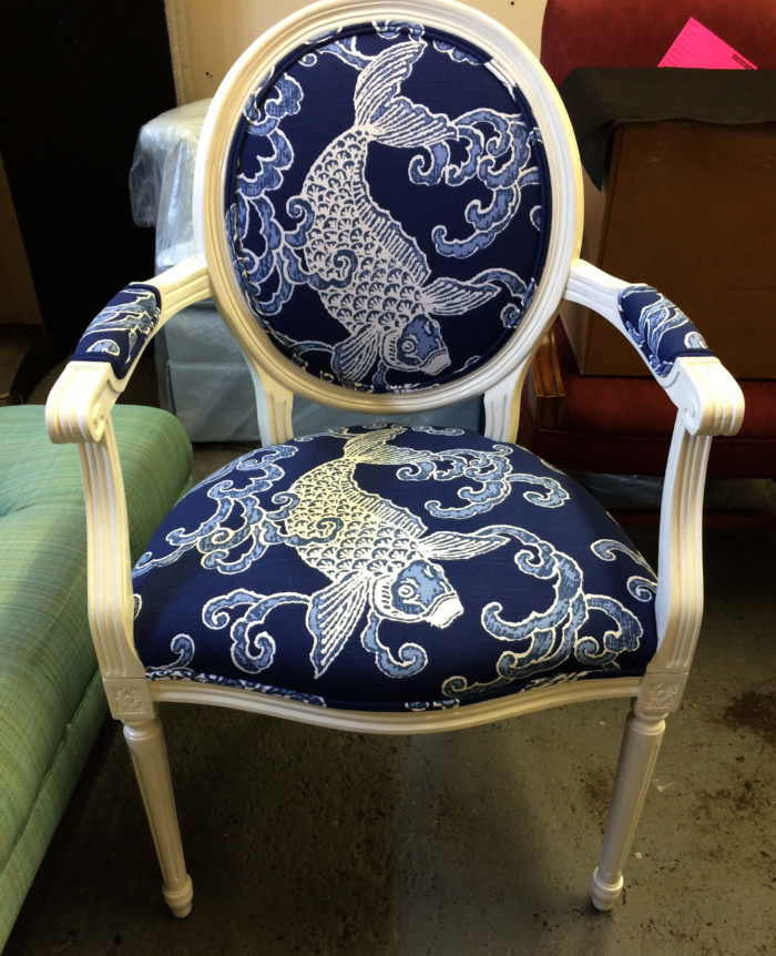 Blue and white chair with threaded Asian-style design of a fish