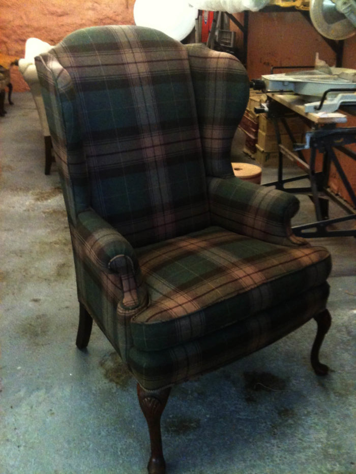 Plaid green wingback chair from Westwood, sitting in workshop